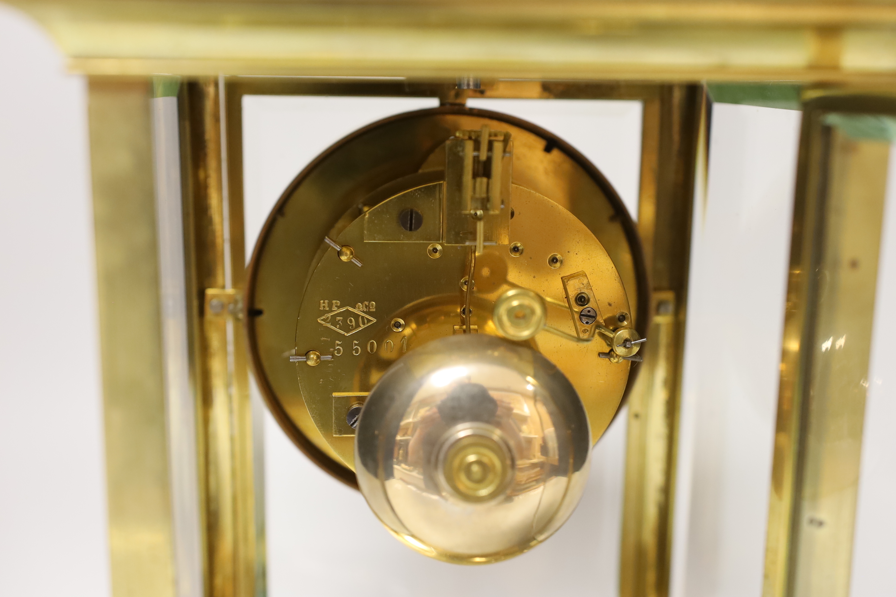 An early 20th century brass four glass mantel clock, 27cm